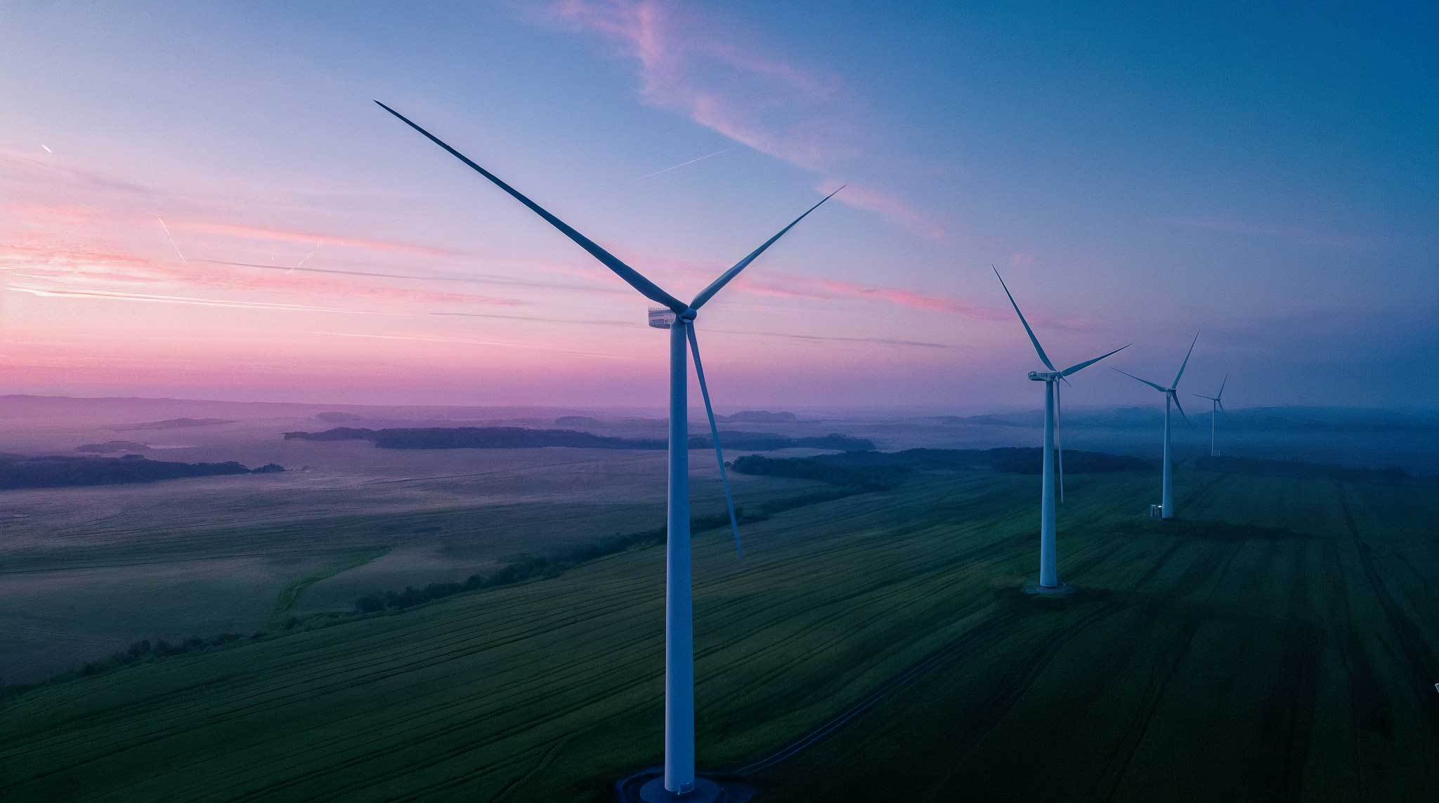 section.d_wind_turbines_standing_on_open_Austrian_farmland_dusk_9728fca4-28d1-4804-a875-4898b299b101-up
